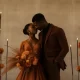 Bride and groom at an intimate micro wedding with orange floral bouquet and candles.